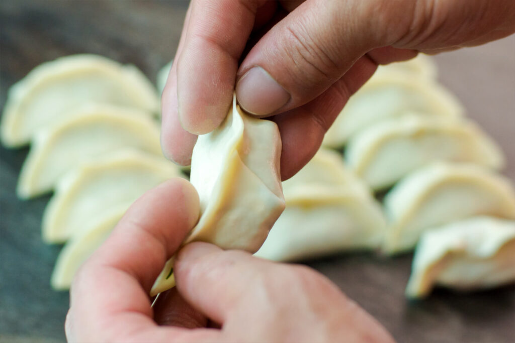 Rows of uncooked gyoza prepared before cooking at Ichi-ban Boshi